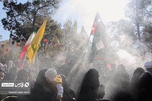 بانوان در تشییع پیکر شهیدان گمنام پرچم های فلسطین و لبنان را در دست دارند.